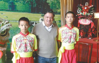 图为纳赛尔·阿卜杜·阿勒(中)与中国舞狮队少年合影。